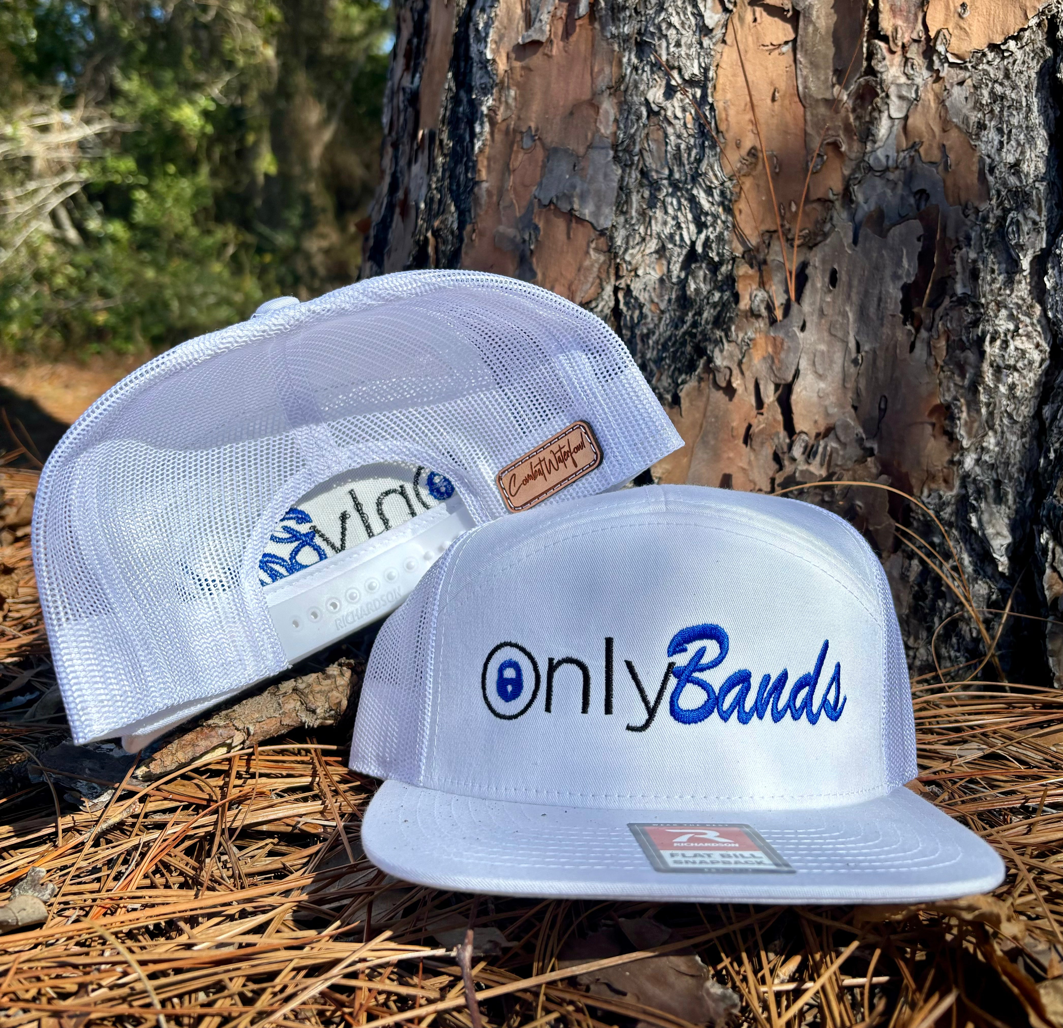 White Richardson 7 Panel OnlyBands embroidered snapback hat with mesh back, on pine needles.