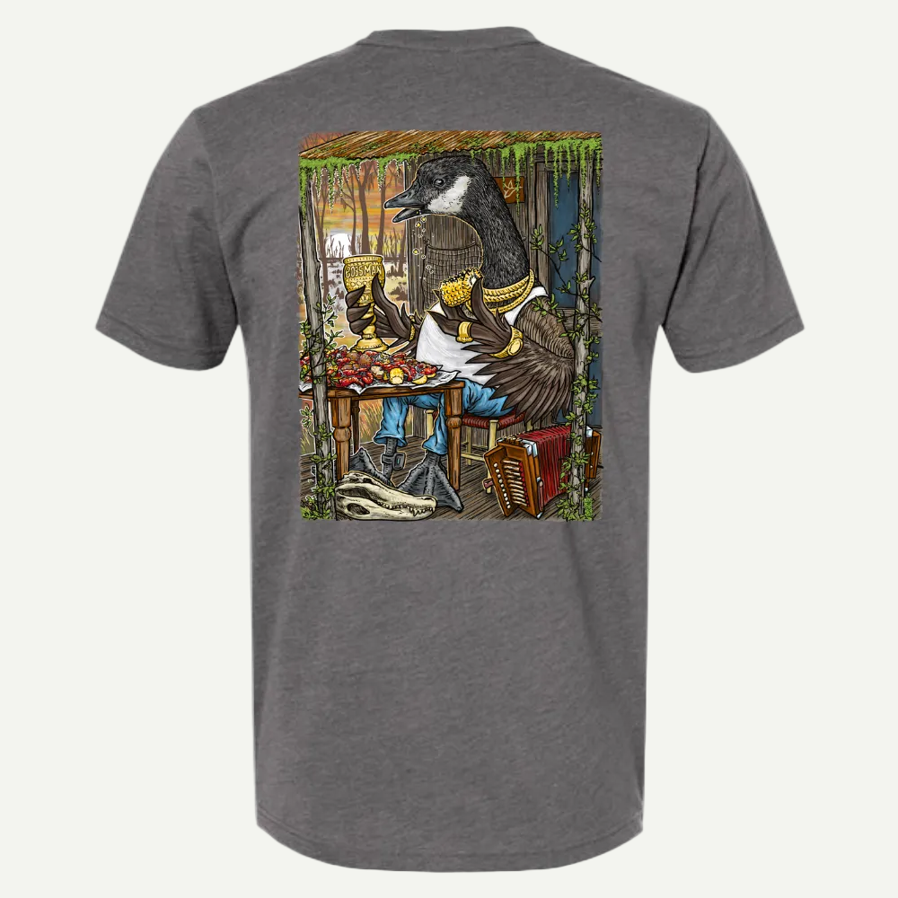 Heather gray tee with a cartoon goose in a bayou scene, eating crawfish and drinking, with an accordion.